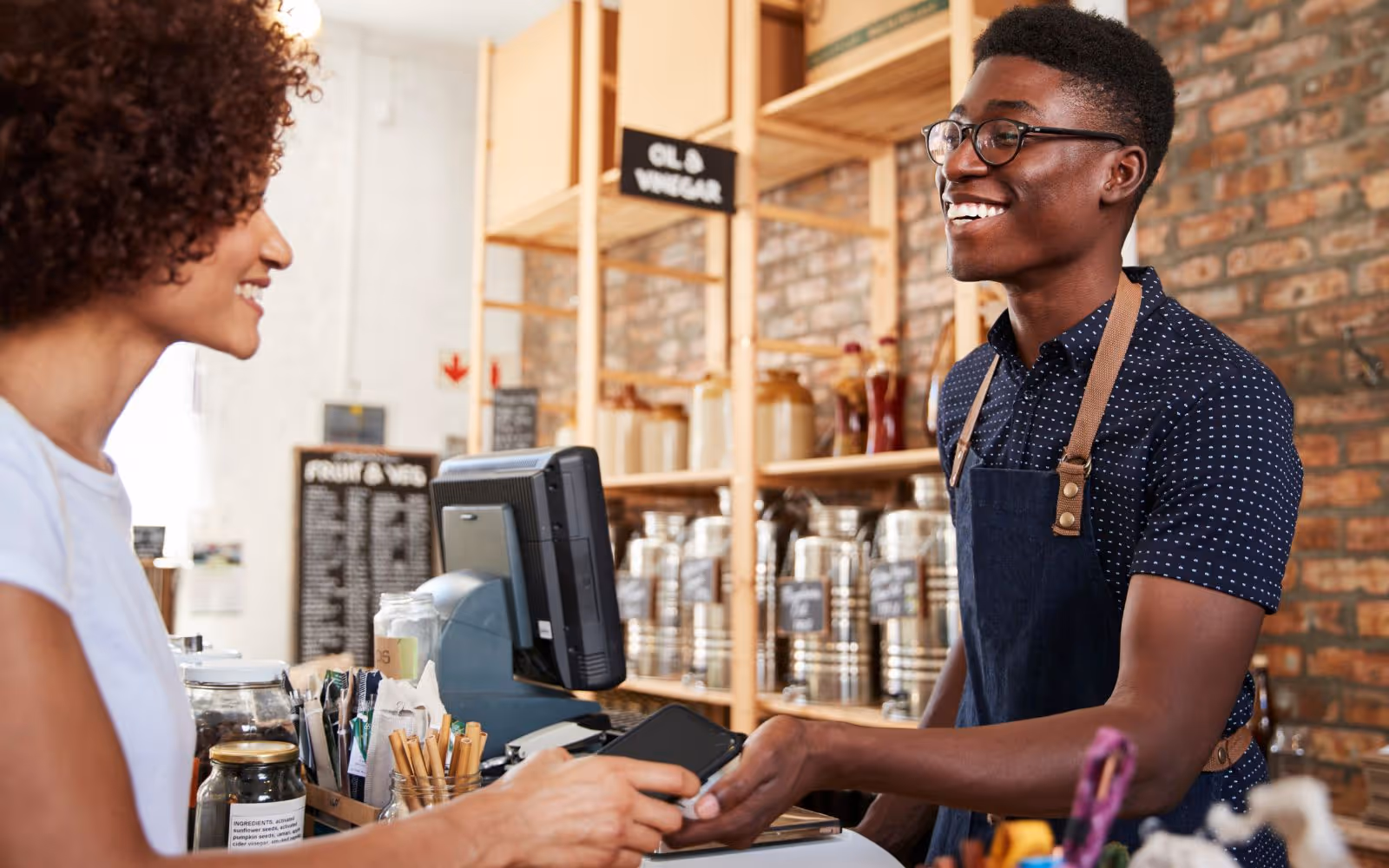 Customer smiles at server in a store. 